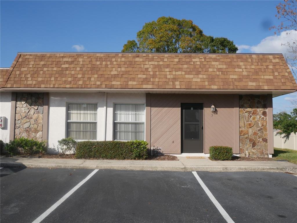 6165 Chesham Drive, Unit 5 New Port Richey, FL 34653 - Photo 1 of 35 a front view of a house with a road
