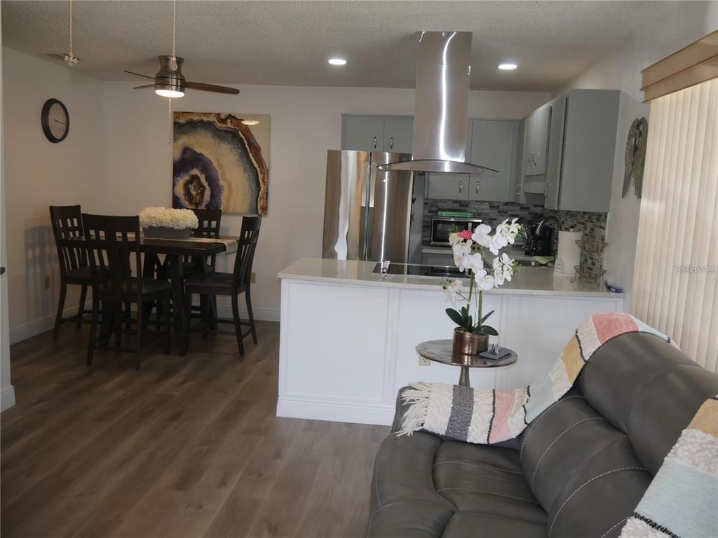 6165 Chesham Drive, Unit 5 New Port Richey, FL 34653 - Photo 11 of 35 a view of a dining room with furniture and wooden floor