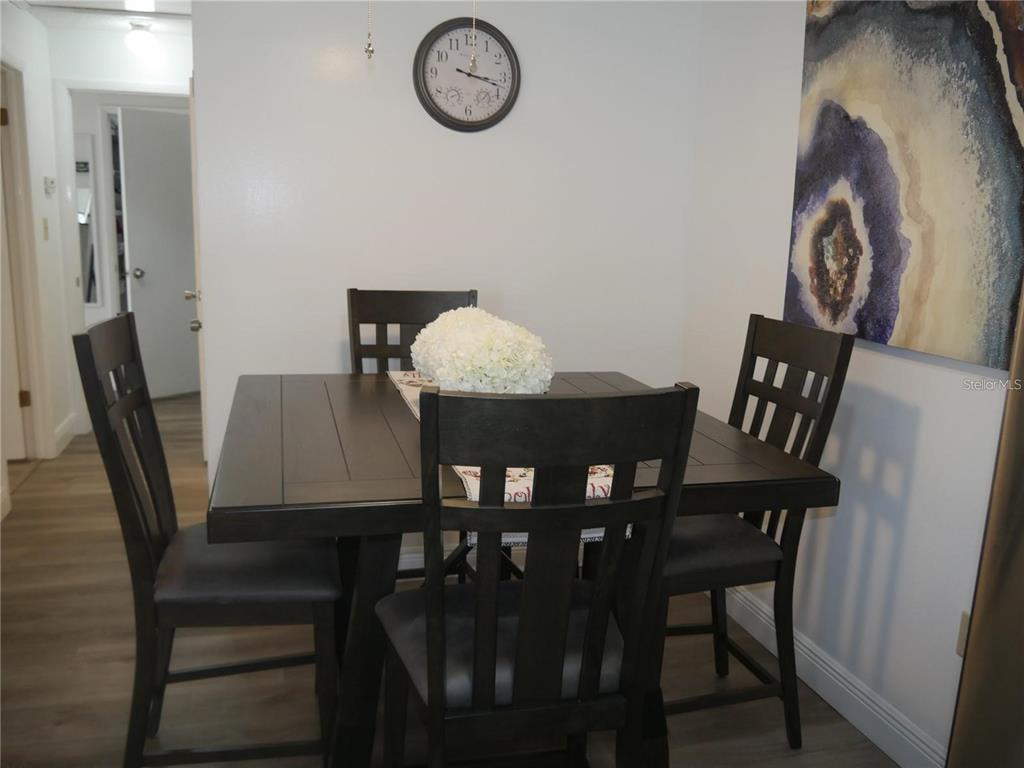 6165 Chesham Drive, Unit 5 New Port Richey, FL 34653 - Photo 12 of 35 a view of a dining room with furniture and wooden floor