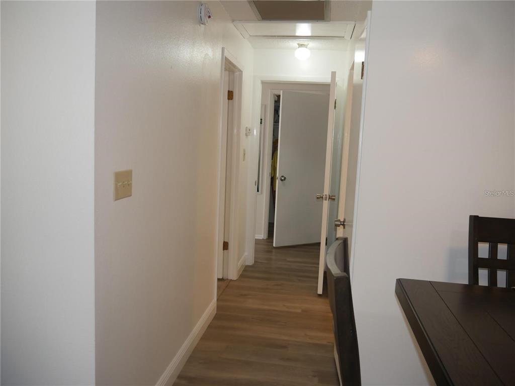 6165 Chesham Drive, Unit 5 New Port Richey, FL 34653 - Photo 13 of 35 a view of a hallway with wooden floor and staircase