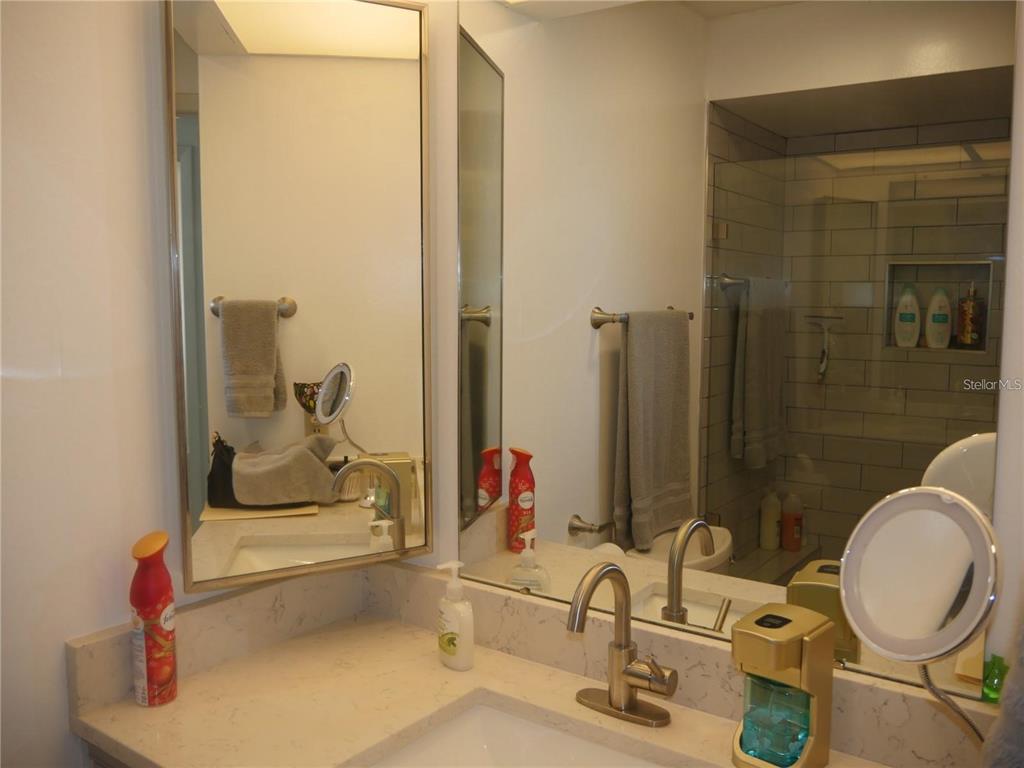 6165 Chesham Drive, Unit 5 New Port Richey, FL 34653 - Photo 16 of 35 a bathroom with a sink and a mirror