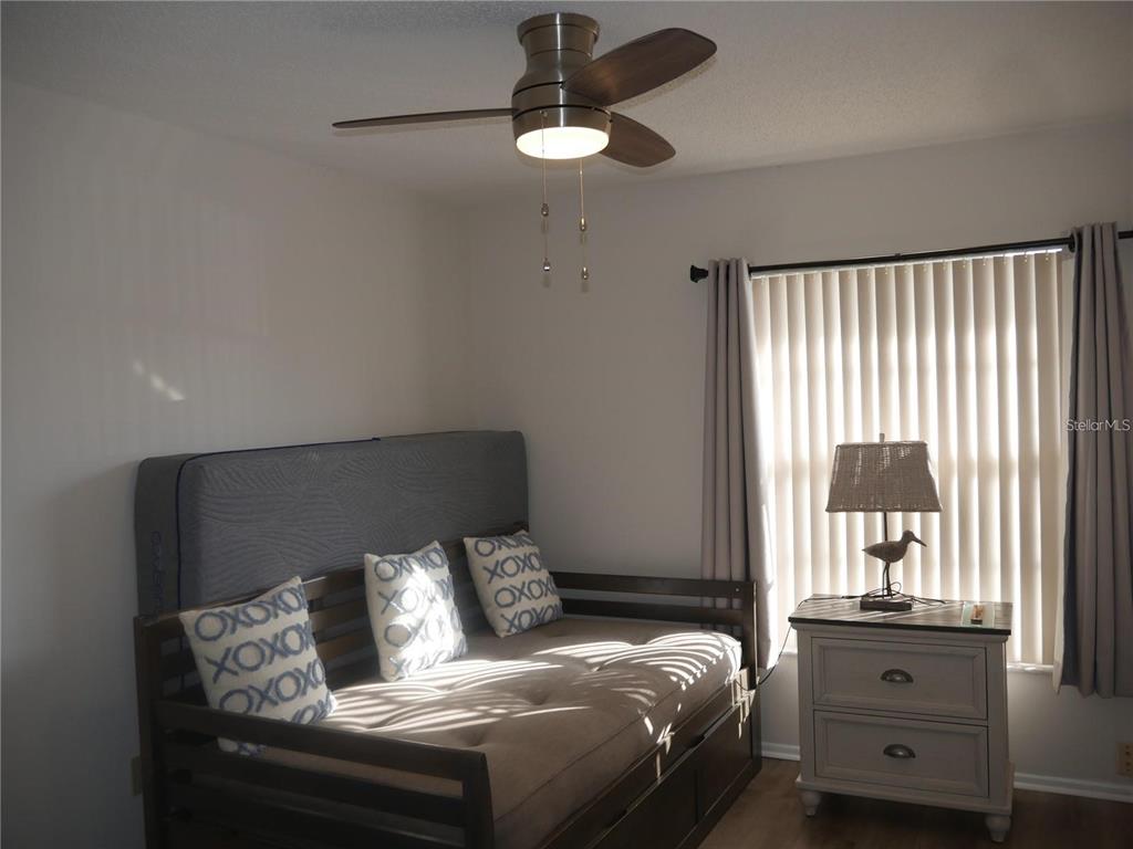 6165 Chesham Drive, Unit 5 New Port Richey, FL 34653 - Photo 20 of 35 a bedroom with a bed and window