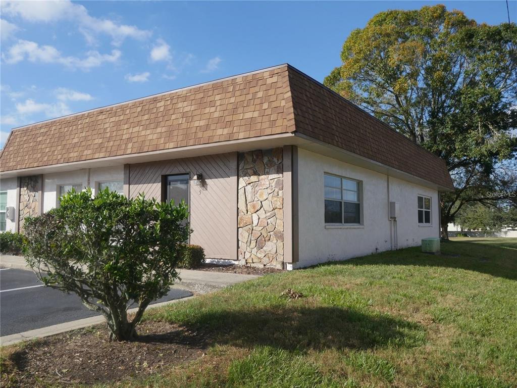 6165 Chesham Drive, Unit 5 New Port Richey, FL 34653 - Photo 2 of 35 a front view of house with garden