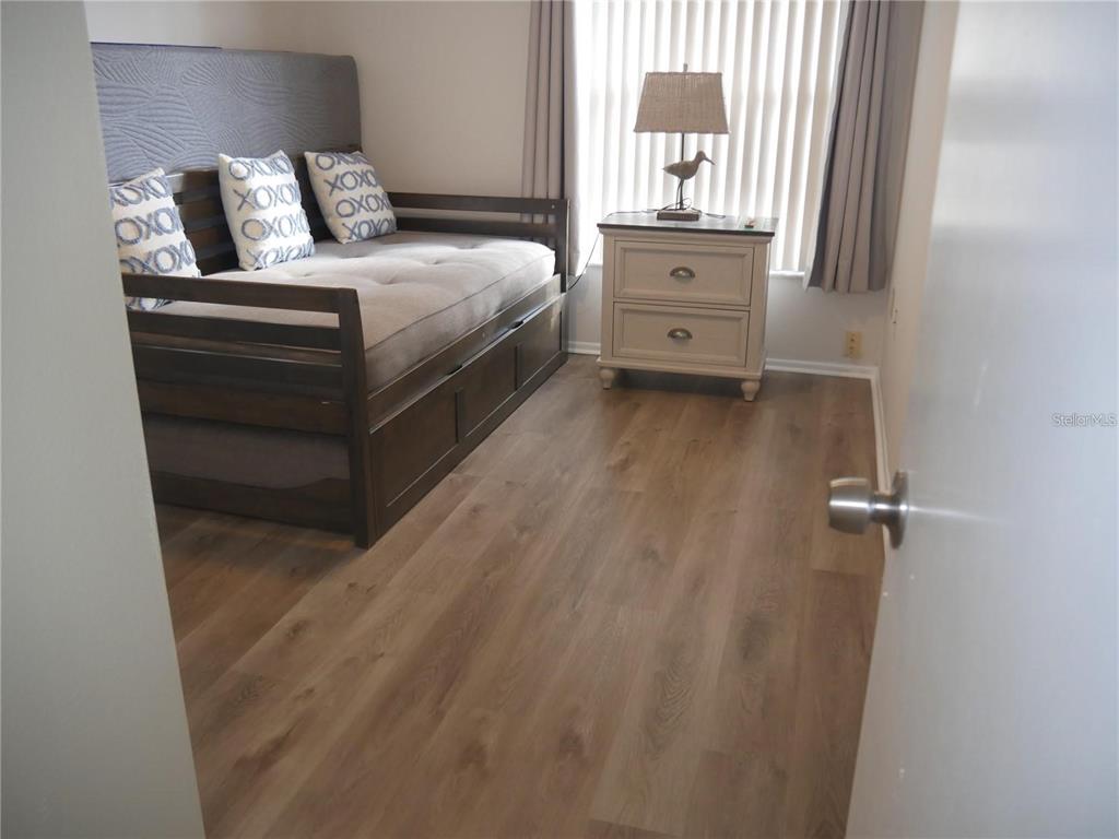 6165 Chesham Drive, Unit 5 New Port Richey, FL 34653 - Photo 22 of 35 a bedroom with a bed and a dresser