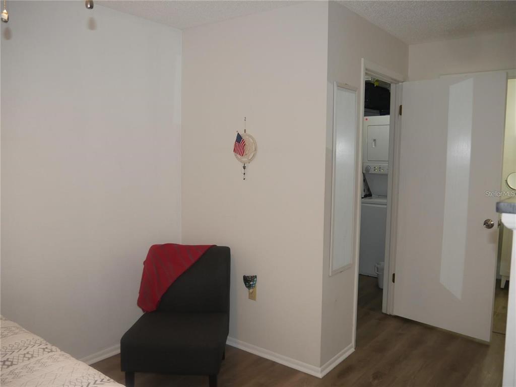 6165 Chesham Drive, Unit 5 New Port Richey, FL 34653 - Photo 25 of 35 a room with wooden floor and closet