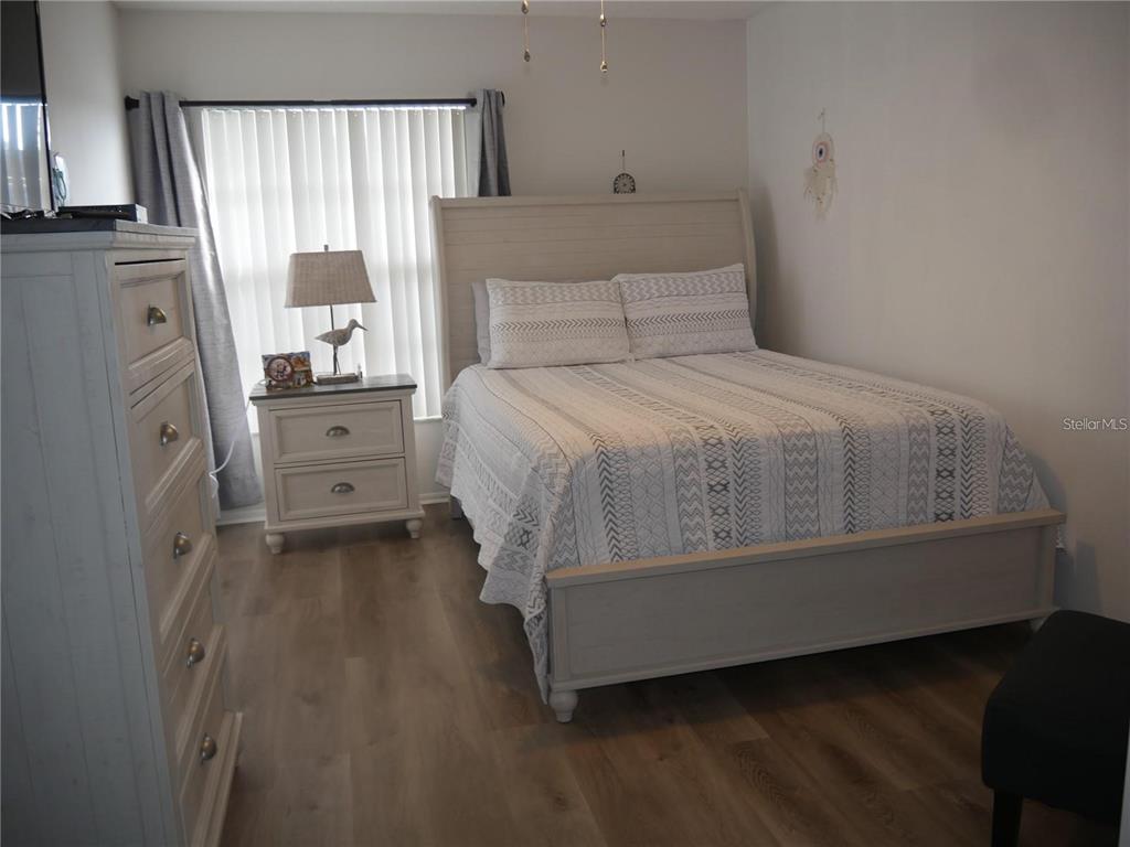 6165 Chesham Drive, Unit 5 New Port Richey, FL 34653 - Photo 26 of 35 a bedroom with a bed and a window