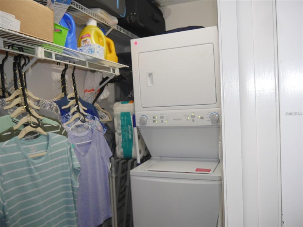 6165 Chesham Drive, Unit 5 New Port Richey, FL 34653 - Photo 27 of 35 a view of storage and utility room with washer and dryer