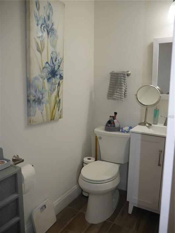 6165 Chesham Drive, Unit 5 New Port Richey, FL 34653 - Photo 28 of 35 a bathroom with a toilet a sink and mirror