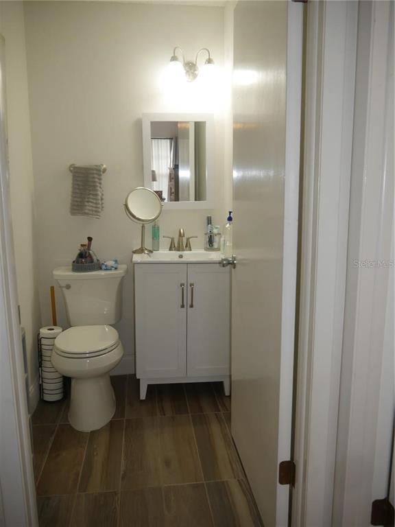 6165 Chesham Drive, Unit 5 New Port Richey, FL 34653 - Photo 29 of 35 a bathroom with a toilet sink and mirror