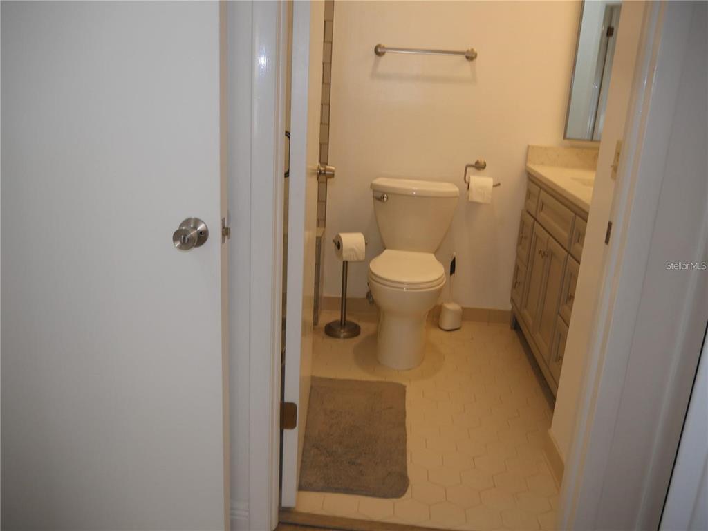 6165 Chesham Drive, Unit 5 New Port Richey, FL 34653 - Photo 31 of 35 a bathroom with a toilet and a shower