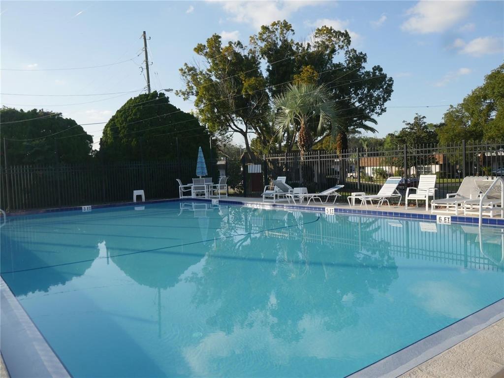6165 Chesham Drive, Unit 5 New Port Richey, FL 34653 - Photo 32 of 35 a view of a lake with houses