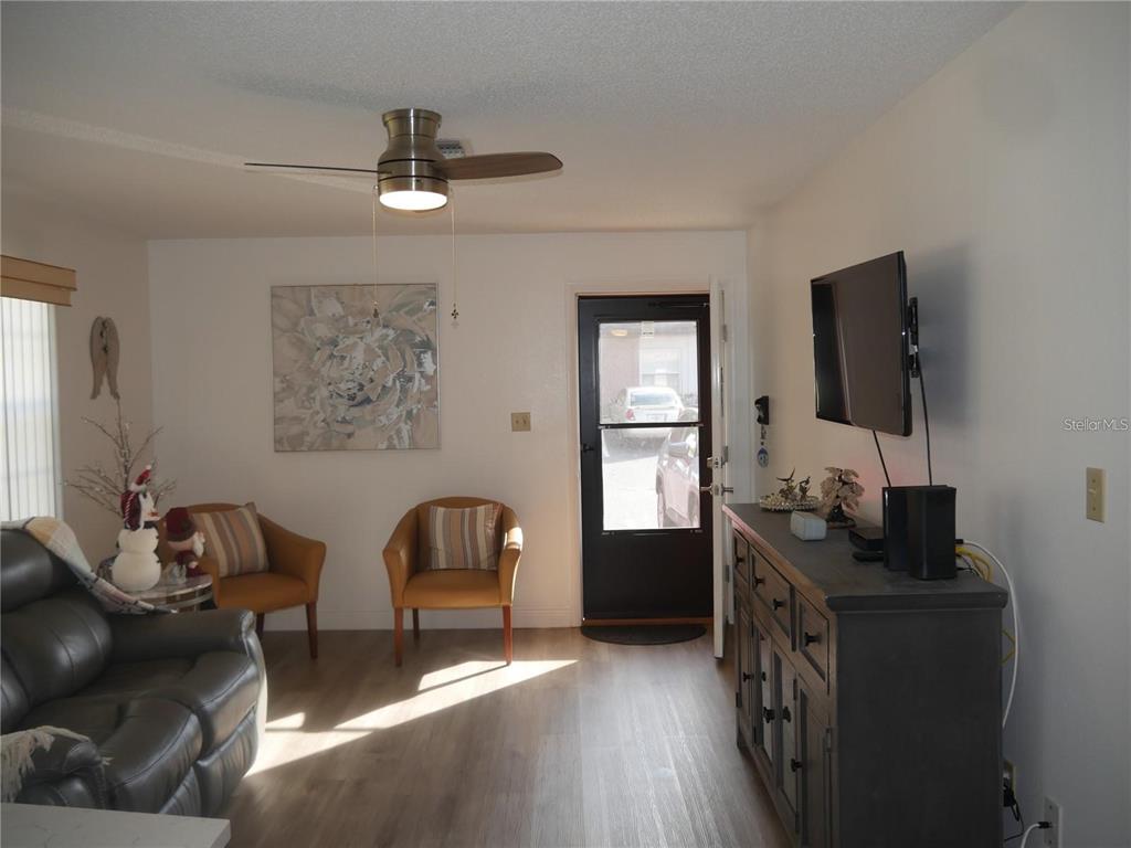 6165 Chesham Drive, Unit 5 New Port Richey, FL 34653 - Photo 4 of 35 a living room with furniture and wooden floor