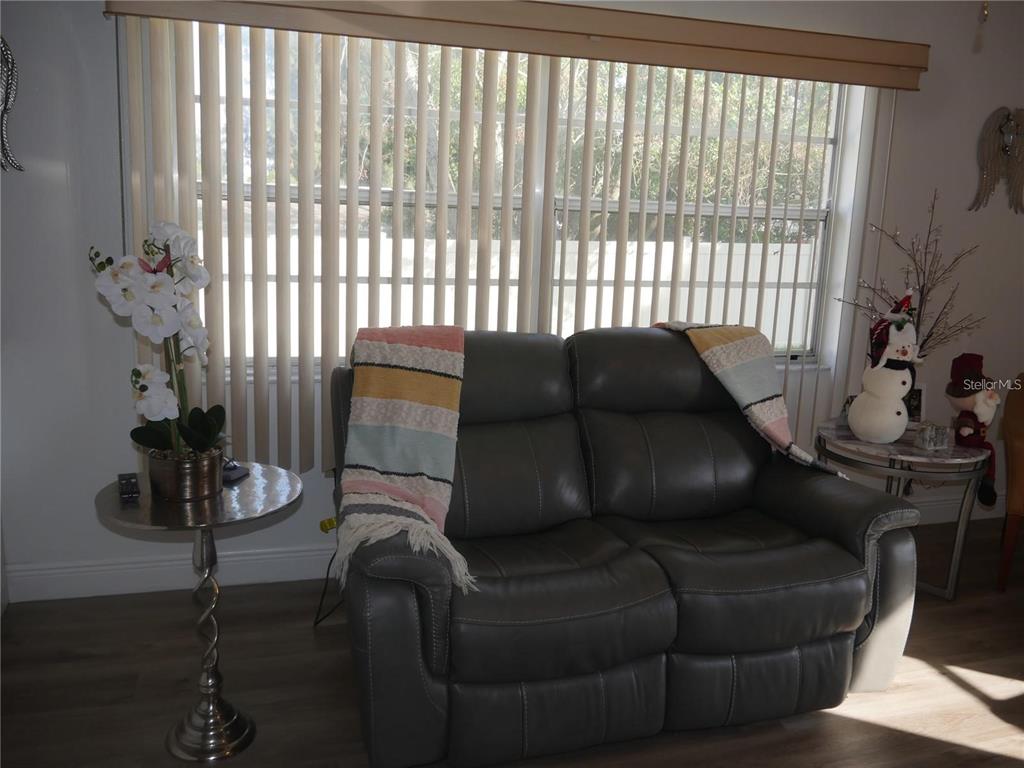 6165 Chesham Drive, Unit 5 New Port Richey, FL 34653 - Photo 5 of 35 a living room with furniture and a window