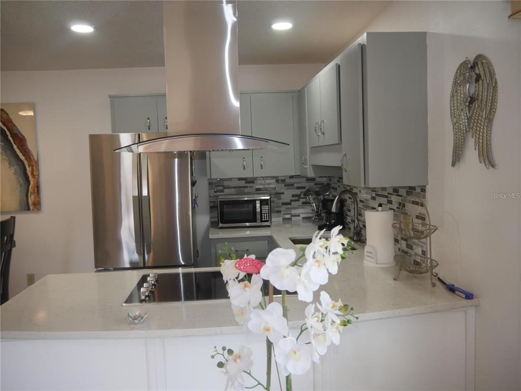 6165 Chesham Drive, Unit 5 New Port Richey, FL 34653 - Photo 8 of 35 a bathroom with a sink a vanity and a large mirror