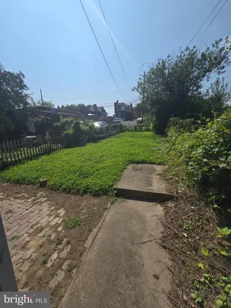 a view of a street with a houses in the background