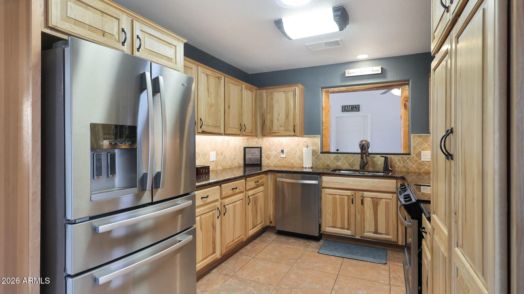 8120 West Williams Road Peoria, AZ 85383 - Photo 12 of 46 a kitchen with stainless steel appliances granite countertop a refrigerator and a sink