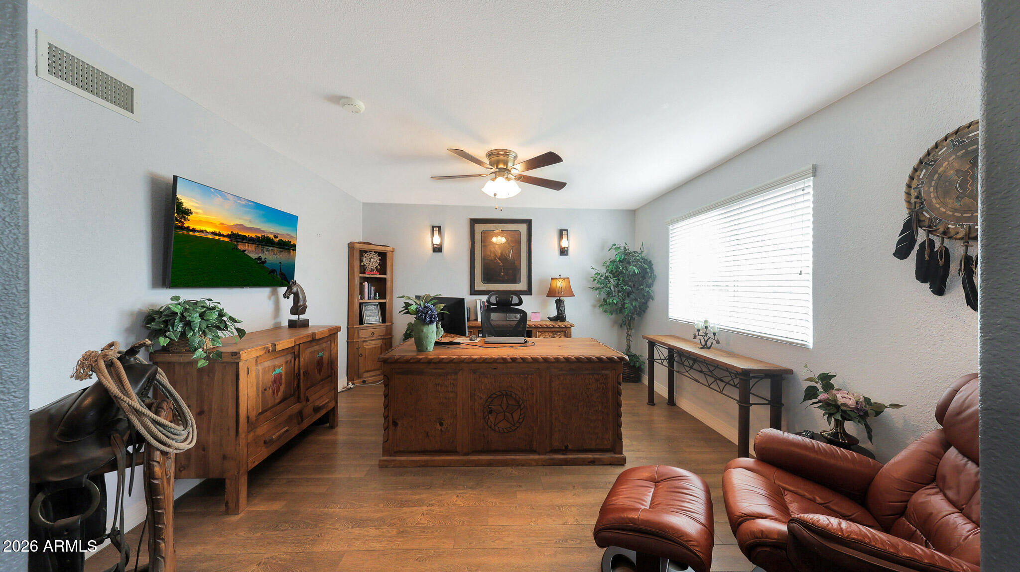 8120 West Williams Road Peoria, AZ 85383 - Photo 8 of 46 a living room with furniture a flat screen tv and a window