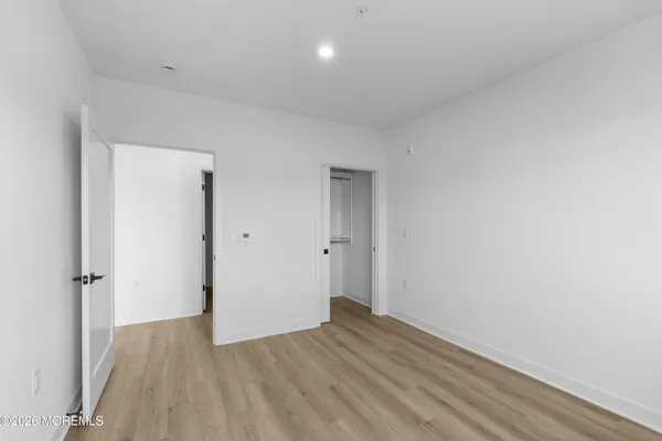a living room with furniture a chandelier and a potted plant