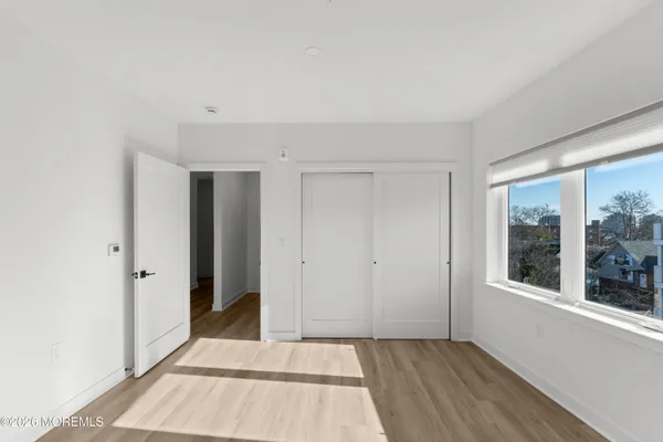 a bed room with a bed and a painting on the wall