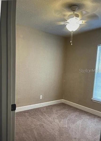96 Redwood Road Ocala, FL 34472 - Photo 7 of 10 a view of a room with a ceiling fan and a window