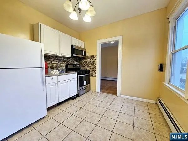 a kitchen with stainless steel appliances a refrigerator sink and cabinets