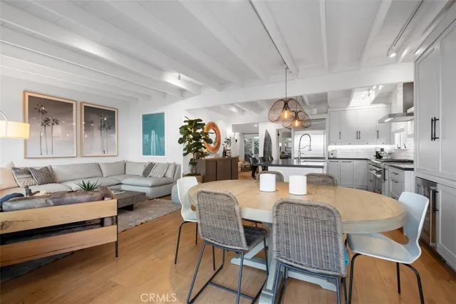 a dining room with furniture a rug and wooden floor