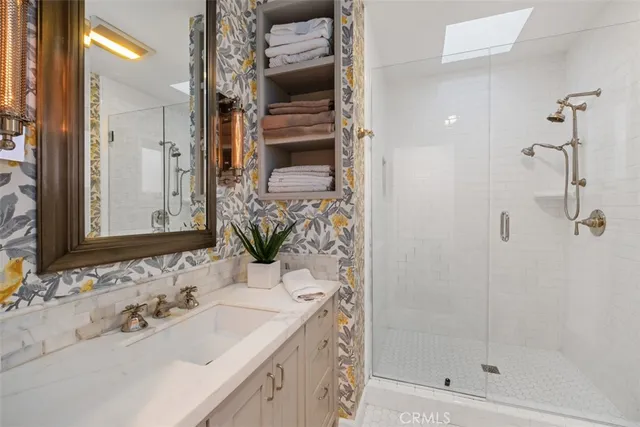 a bathroom with a shower sink and mirror