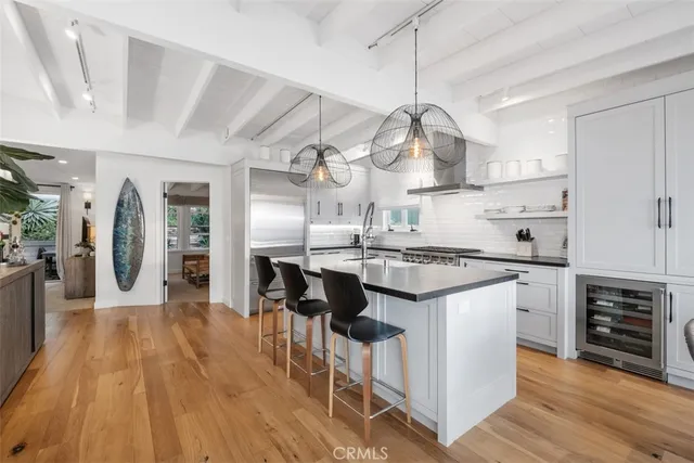 a kitchen with stainless steel appliances granite countertop a lot of counter space and wooden floors