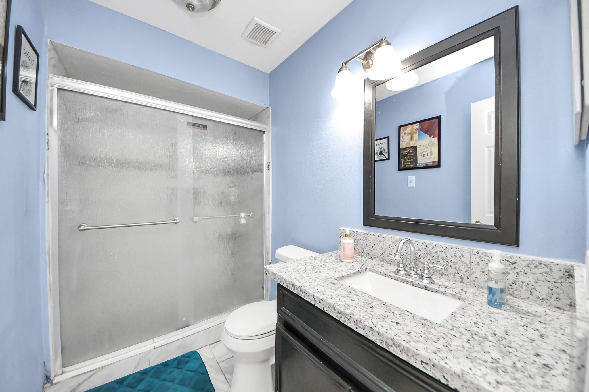 4155 Amir Street Houston, TX 77072 - Photo 31 of 43 a bathroom with a granite countertop sink toilet and shower