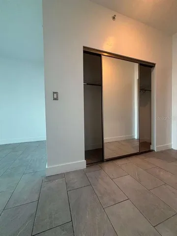 a view of an empty room with closet