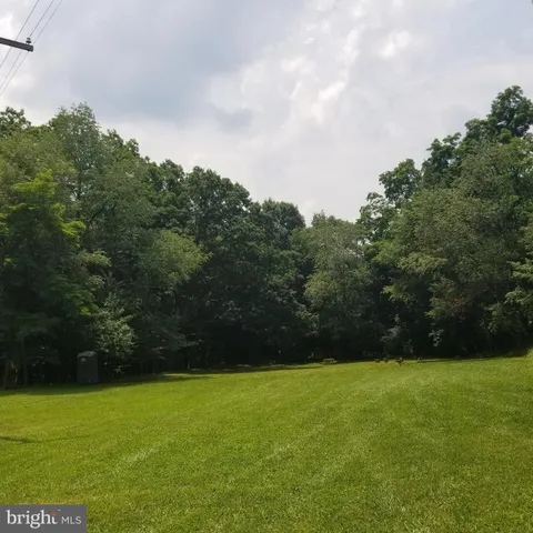 a view of a field with an trees in the background