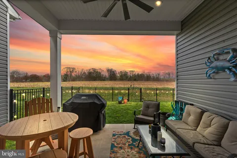 a view of a patio with a table chairs and a backyard