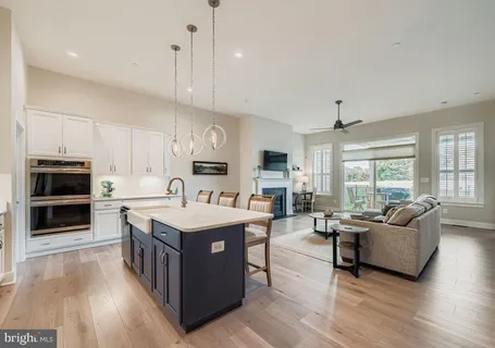 a open kitchen with stainless steel appliances granite countertop a stove oven and a refrigerator