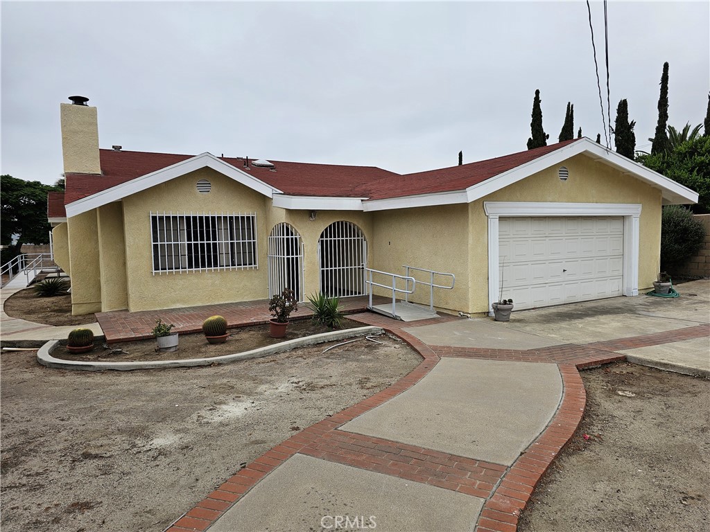 13623 Arrow Route Fontana, CA 92335 - Photo 1 of 1 a front view of a house with a yard