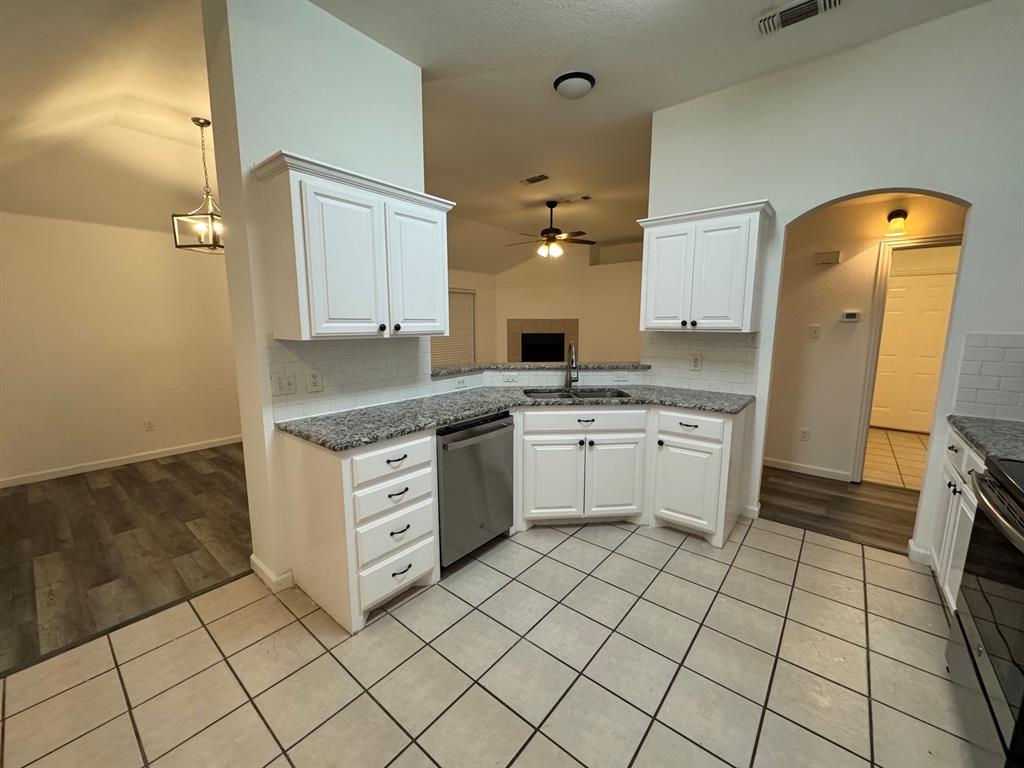 6611 Rockdale Road Fort Worth, TX 76134 - Photo 11 of 32 a kitchen with a stove sink and cabinets