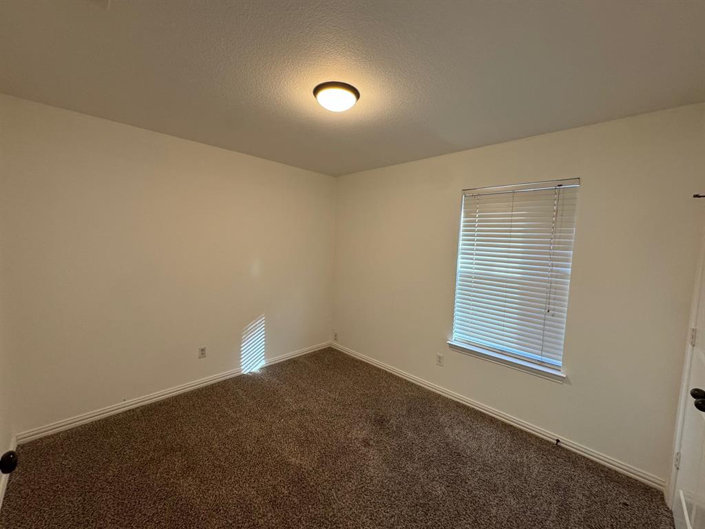 6611 Rockdale Road Fort Worth, TX 76134 - Photo 18 of 32 an empty room with a window