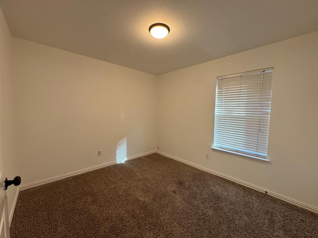 6611 Rockdale Road Fort Worth, TX 76134 - Photo 19 of 32 an empty room with a window