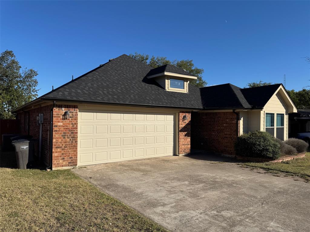 6611 Rockdale Road Fort Worth, TX 76134 - Photo 2 of 32 a front view of a house with a yard and garage
