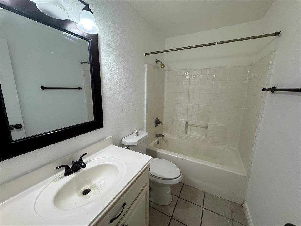 6611 Rockdale Road Fort Worth, TX 76134 - Photo 23 of 32 a bathroom with a sink toilet and shower