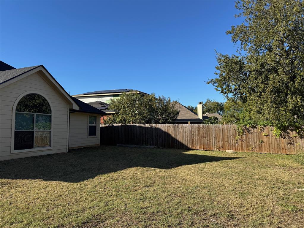 6611 Rockdale Road Fort Worth, TX 76134 - Photo 28 of 32 a front view of a house with a yard