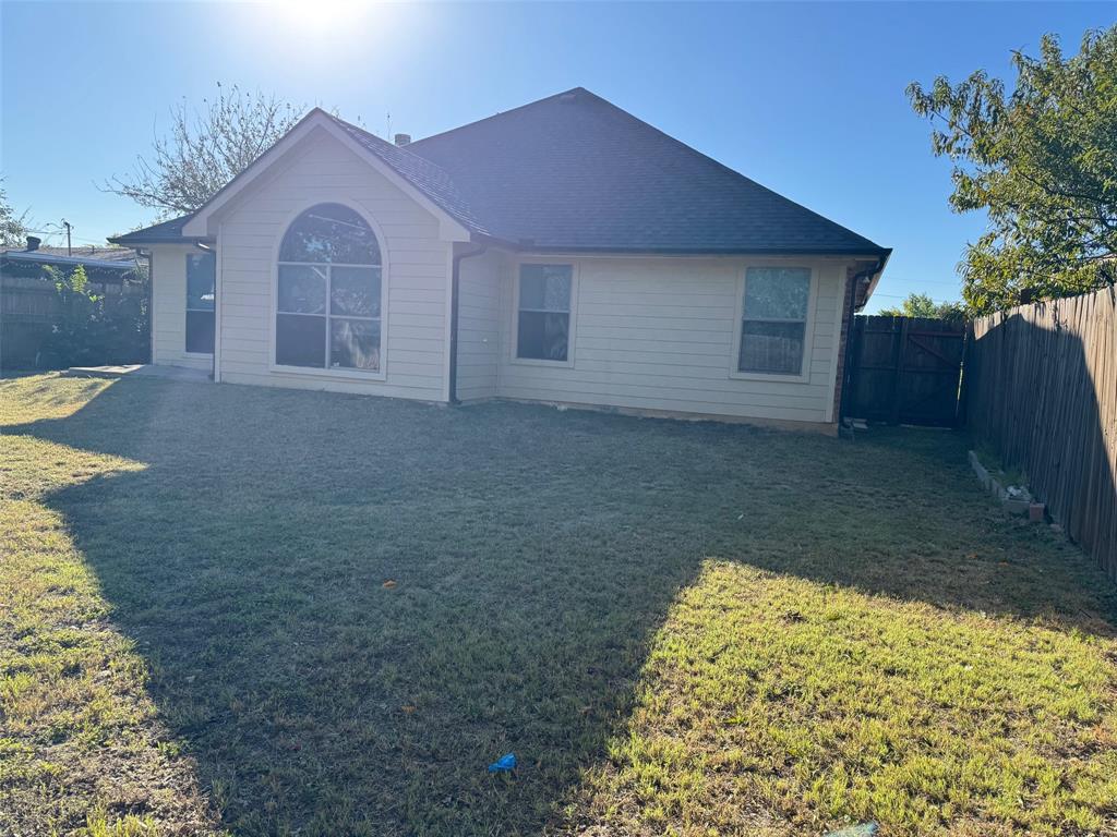 6611 Rockdale Road Fort Worth, TX 76134 - Photo 29 of 32 a view of a house with a yard