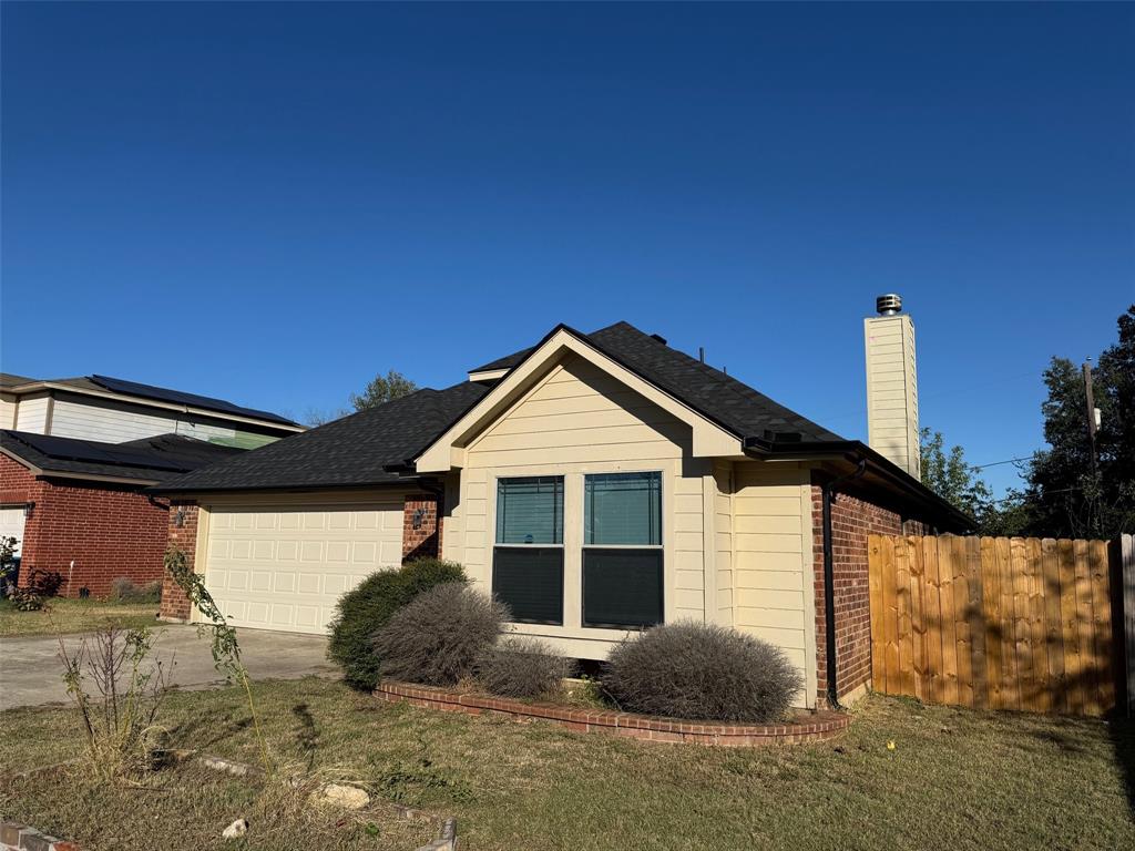 6611 Rockdale Road Fort Worth, TX 76134 - Photo 3 of 32 a front view of a house with garden