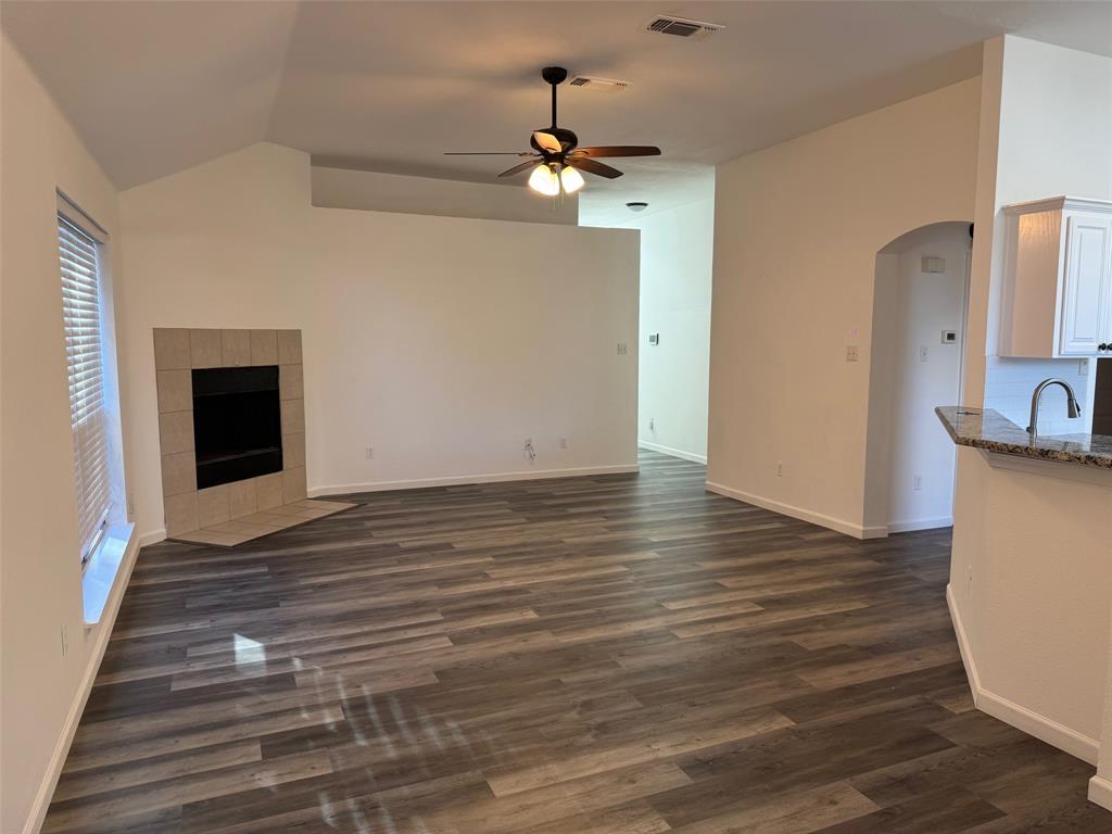 6611 Rockdale Road Fort Worth, TX 76134 - Photo 5 of 32 a view of an empty room with wooden floor and a fireplace