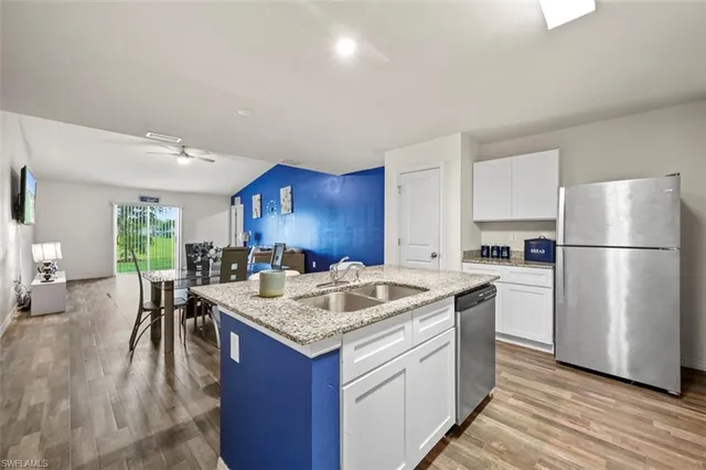 a kitchen with a center island appliances and cabinets