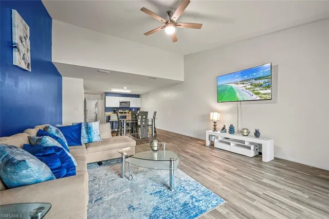 a living room with furniture and wooden floor