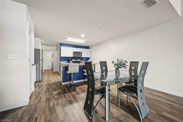 a view of a dining room with furniture and wooden floor