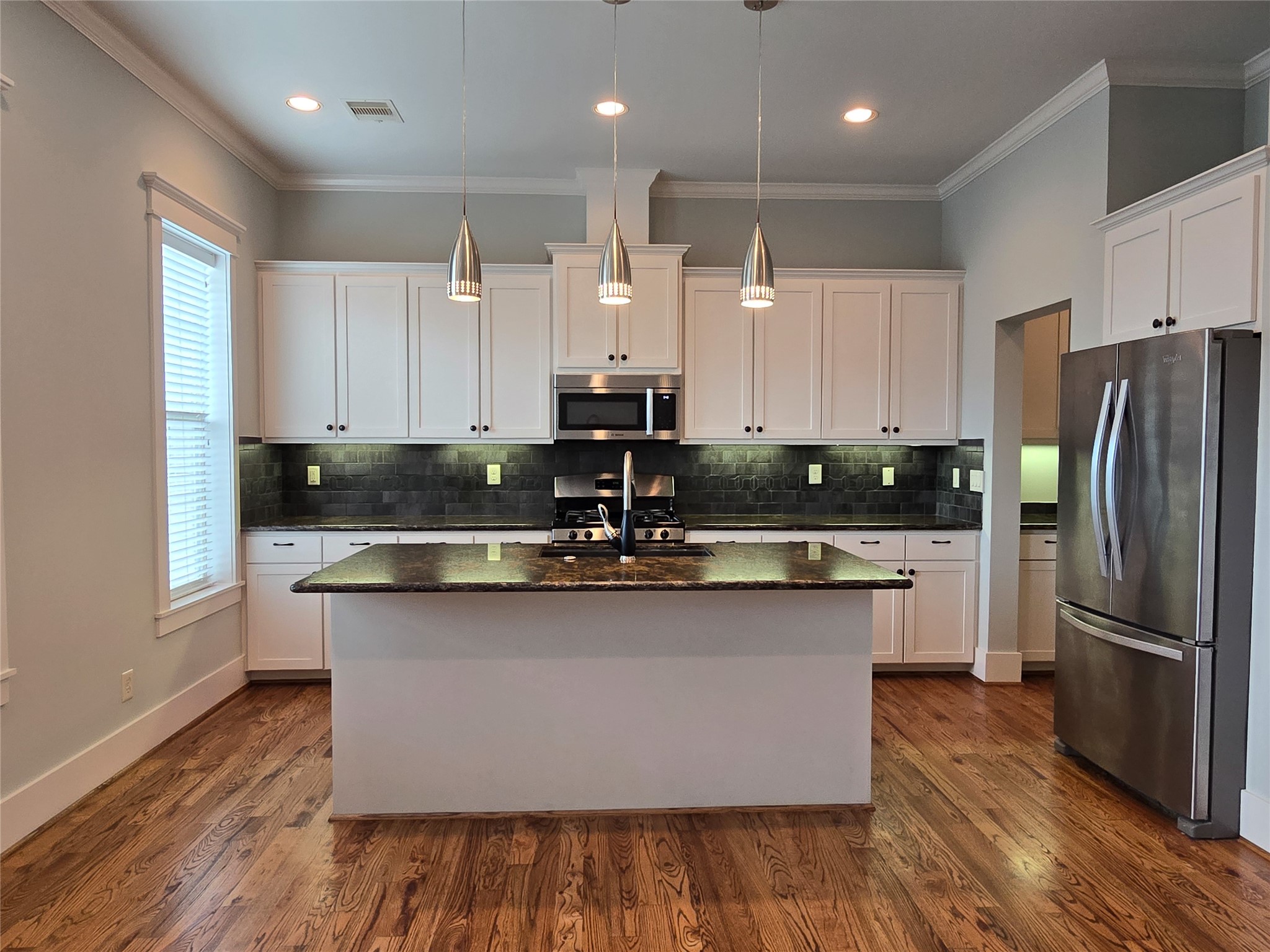 4109 Allen Street Houston, TX 77007 - Photo 14 of 42 Chef's kitchen complete with stainless steel appliances, granite countertops, great lighting and soft close cabinets & drawers. The oversized island allows for additional bar area seating.