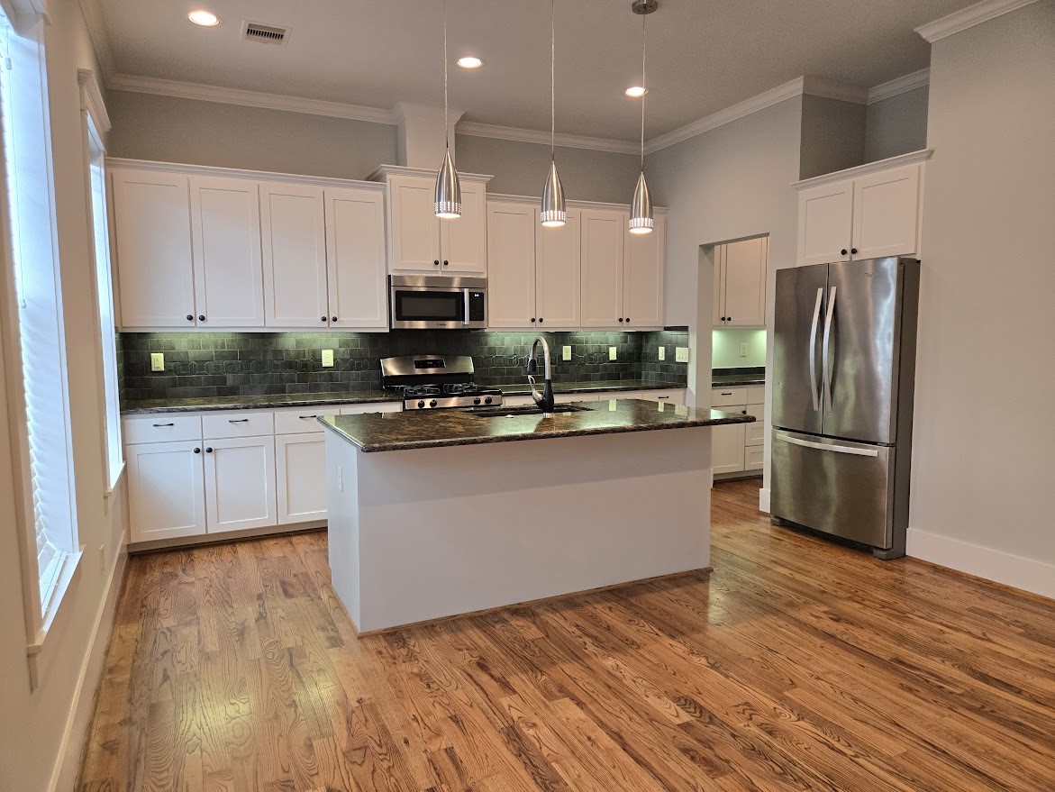 4109 Allen Street Houston, TX 77007 - Photo 15 of 42 Truly a dream kitchen. Beautiful stainless steel appliances and plenty of counterspace. Doorway leads to Butler's Pantry area with a walk-in pantry and plenty of built-in cabinets & drawers for extra storage.