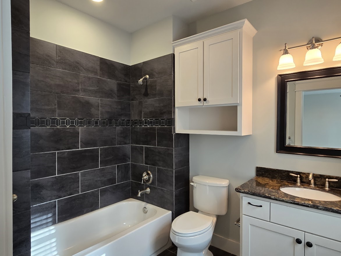 4109 Allen Street Houston, TX 77007 - Photo 24 of 42 Ensuite full bathroom with dark, elegant tiles in the shower.