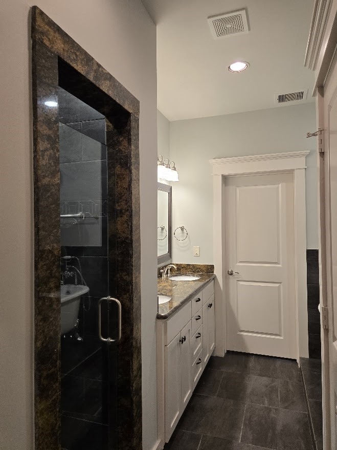 4109 Allen Street Houston, TX 77007 - Photo 30 of 42 Luxurious granite & tile walk-in shower with glass door and a sitting bench.